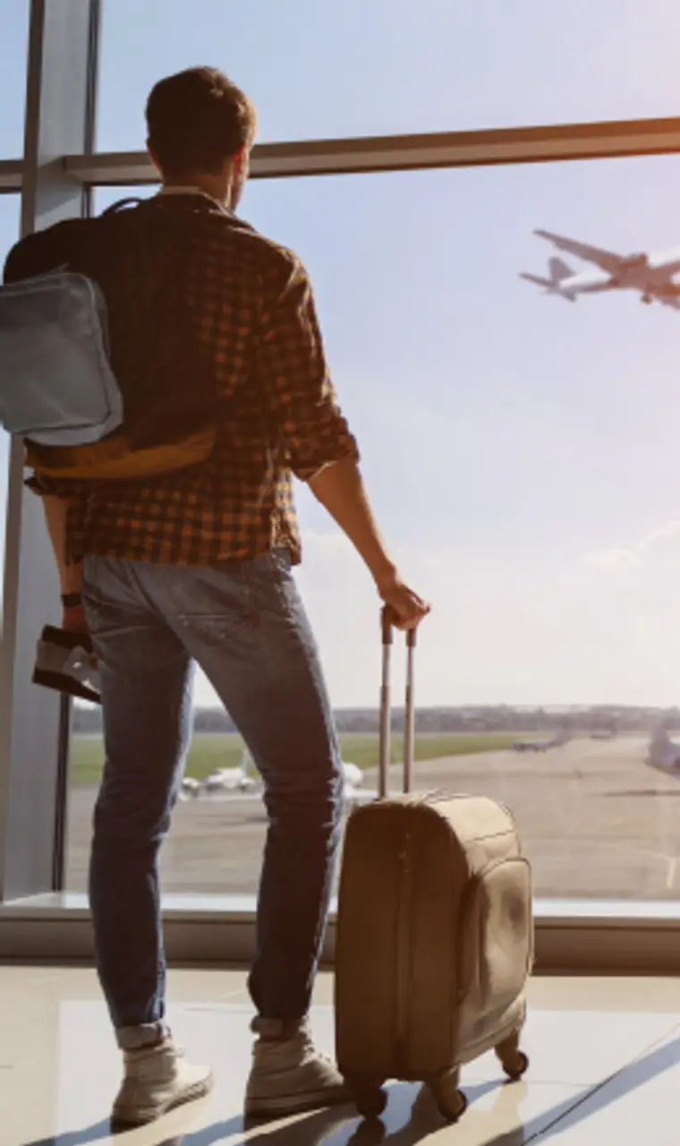 Traveler with luggage at airport